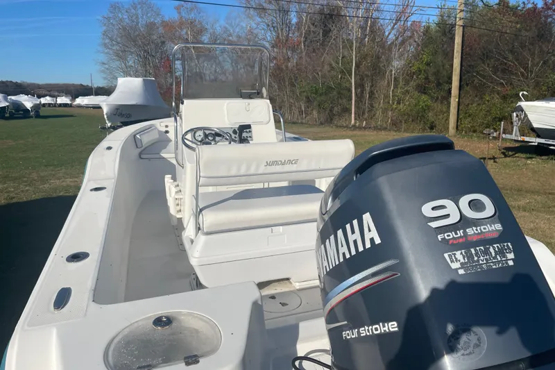 Slide: The Image of 2010 Sundance NX19 boat with Yamaha 90 Four Stroke engine, parked outdoors. - 7