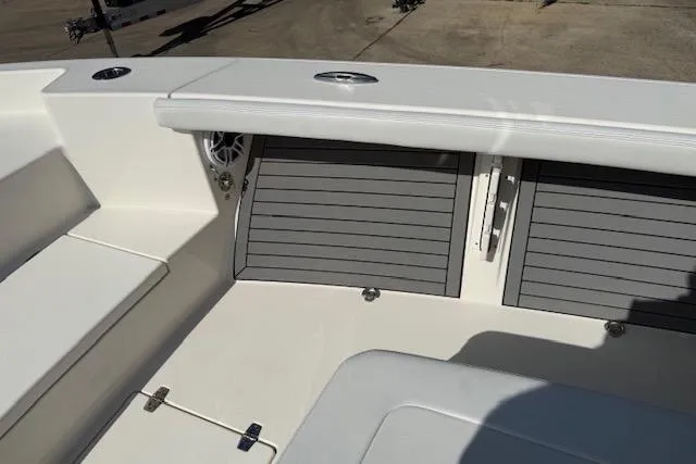Slide: The Image of 2021 Pathfinder 2700 Open boat deck with storage compartments and fishing rod holders. - 16