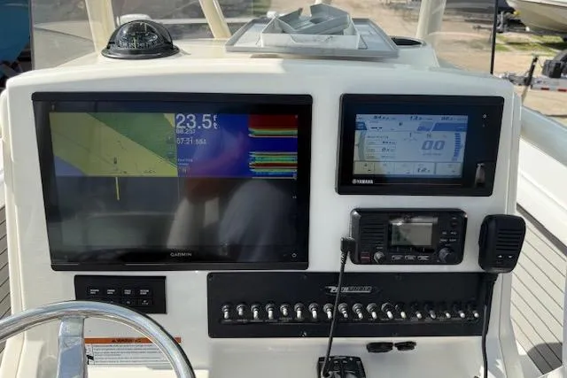 Slide: The Image of Control panel on a 2021 Pathfinder 2700 Open boat, featuring switches and dials. - 20