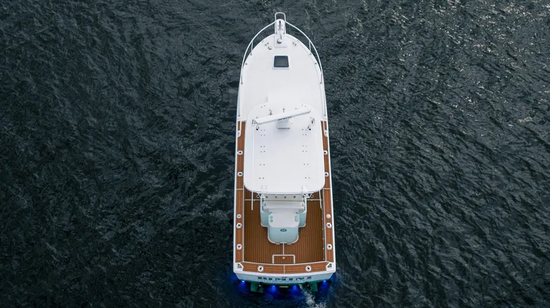 Slide: The Image of Aerial view of 2009 Bimini 24 Center Console boat on open water. - 11