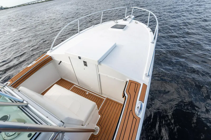 Slide: The Image of 2009 Bimini 24 Center Console boat on water, featuring sleek deck design. - 15