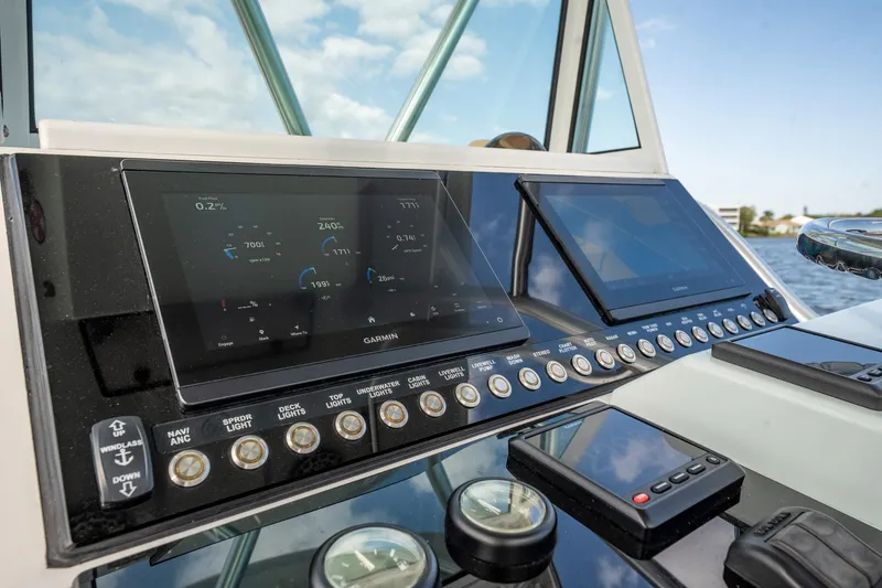 Slide: The Image of Control panel of a 2009 Bimini 24 Center Console boat with navigation screens. - 21