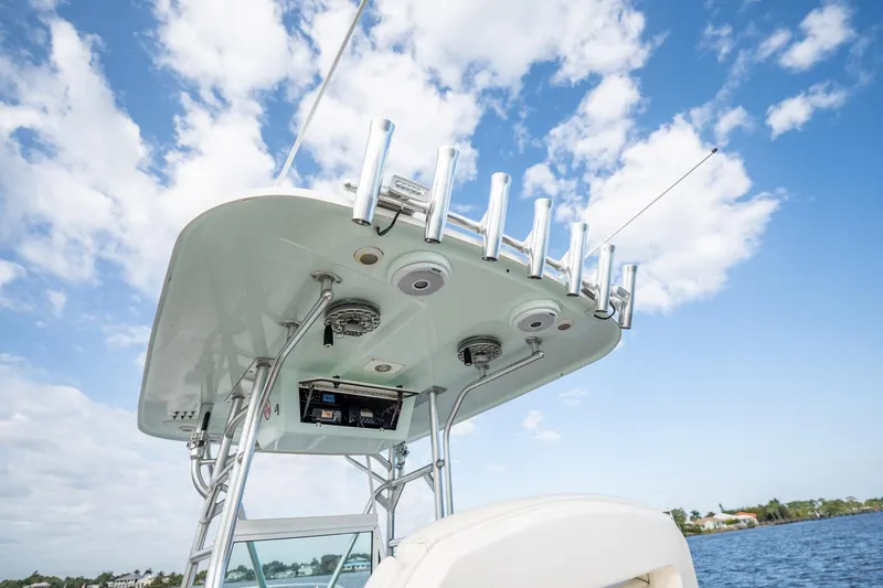 Slide: The Image of 2009 Bimini 24 Center Console boat with rod holders under a clear blue sky. - 25
