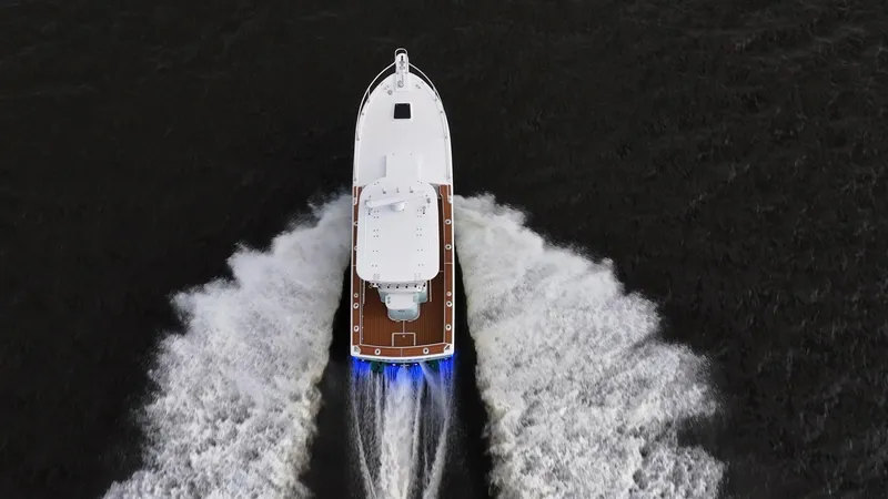 Slide: The Image of Aerial view of 2009 Bimini 24 Center Console boat cruising on water. - 28