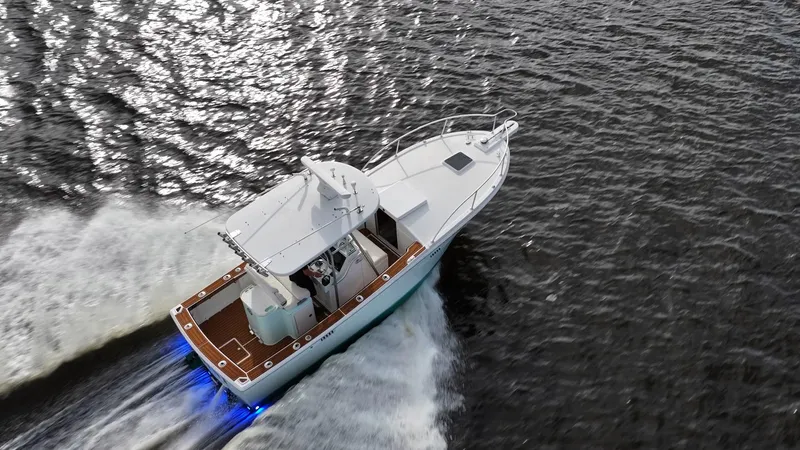 Slide: The Image of 2009 Bimini 24 Center Console boat cruising on open water, aerial view. - 29