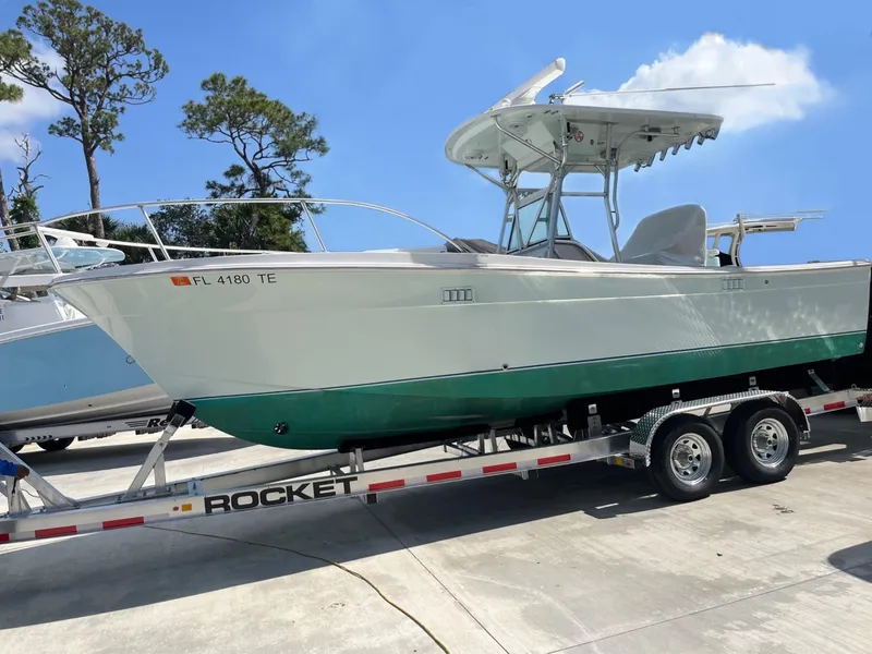 Slide: The Image of 2009 Bimini 24 Center Console boat on trailer, parked outdoors. - 32