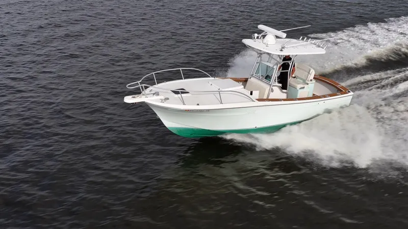 Slide: The Image of 2009 Bimini 24 Center Console boat cruising on open water. - 4