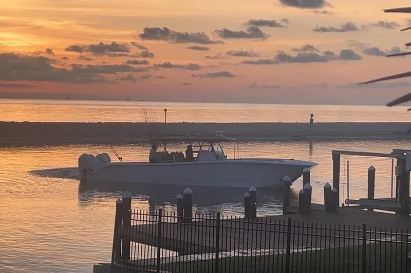 The Image of 2023 Invincible 46 Catamaran on trailer under cloudy sky, side view. - 1