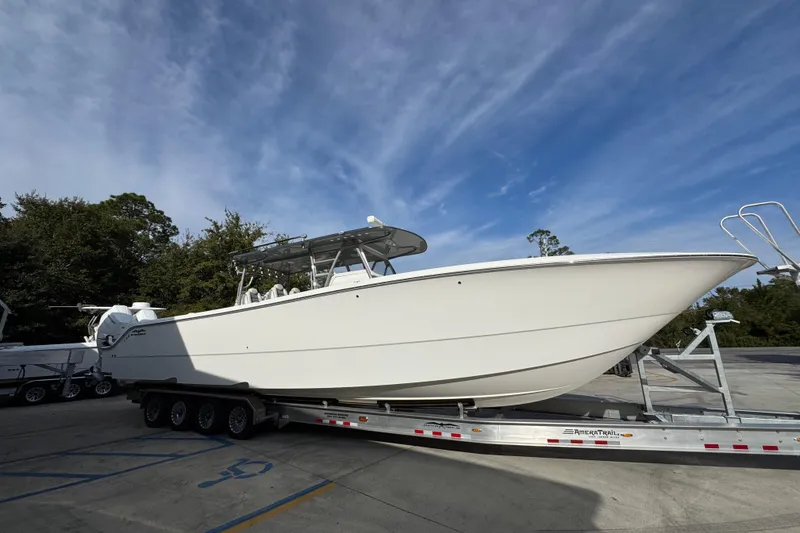 Slide: The Image of 2023 Invincible 46 Catamaran on trailer under blue sky, side view. - 10