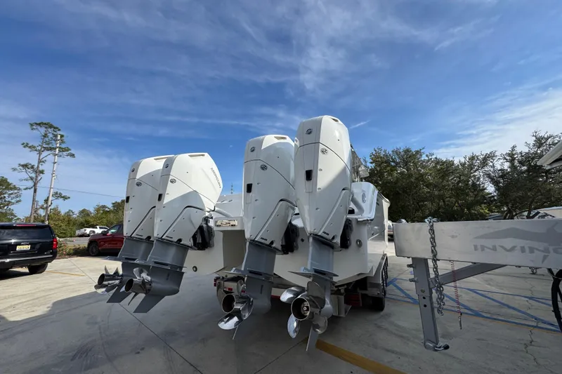 Slide: The Image of 2023 Invincible 46 Catamaran with triple outboard engines on a trailer. - 13