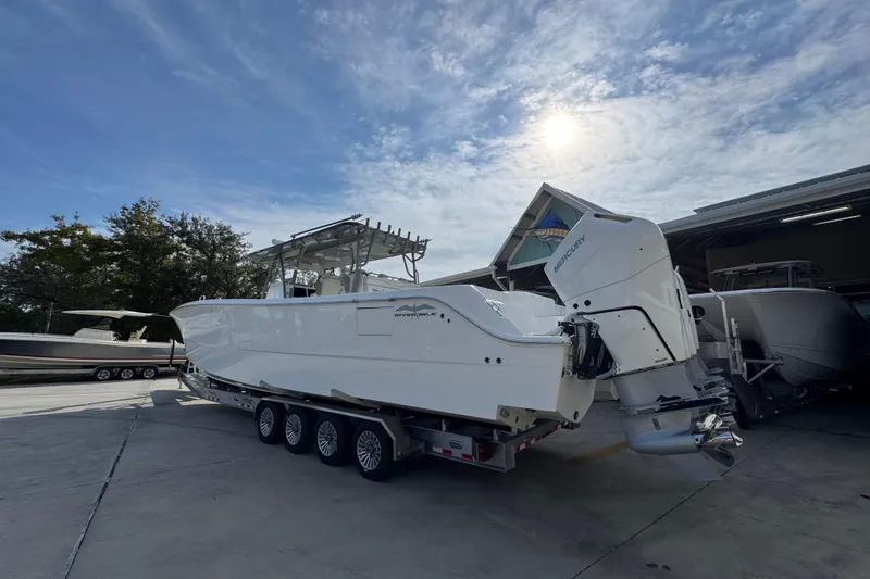Slide: The Image of 2023 Invincible 46 Catamaran on trailer under sunny sky. - 16