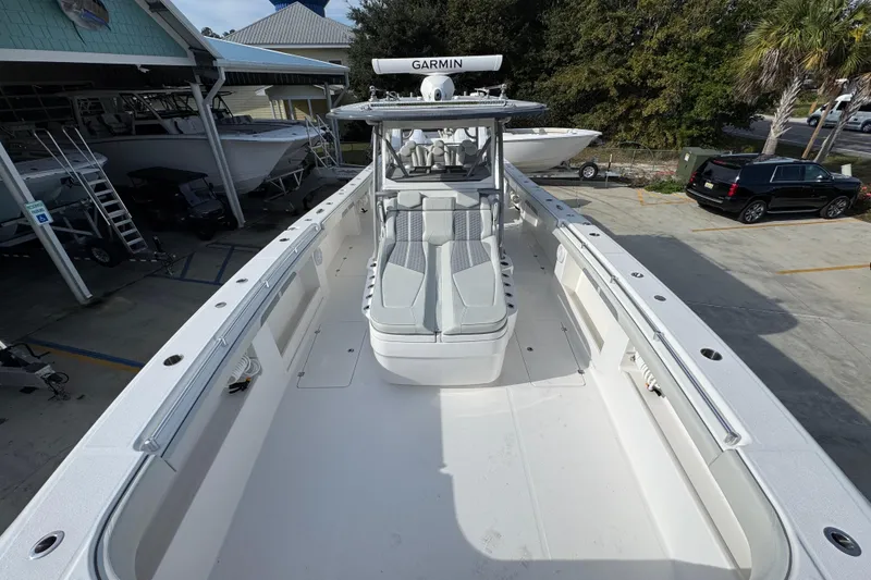 Slide: The Image of 2023 Invincible 46 Catamaran with spacious deck and modern design in a marina setting. - 20