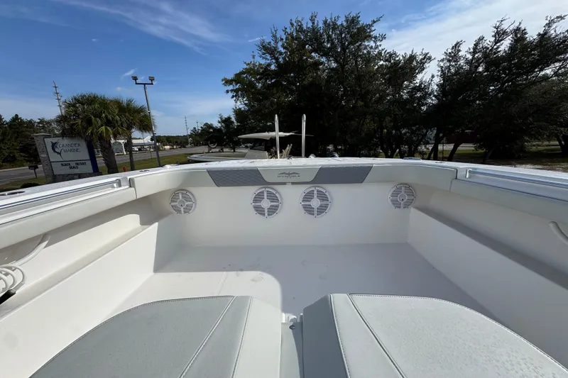 Slide: The Image of 2023 Invincible 46 Catamaran deck with seating and speakers, under a clear blue sky. - 22