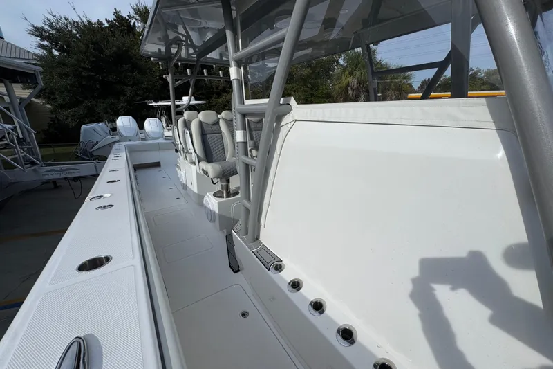 Slide: The Image of 2023 Invincible 46 Catamaran interior with seating and rod holders, showcasing modern design. - 26