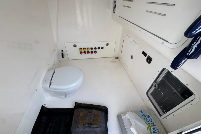 Slide: The Image of 2023 Invincible 46 Catamaran interior with toilet and control panel. - 27