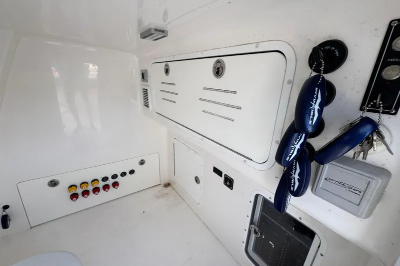 Slide: The Image of 2023 Invincible 46 Catamaran interior with control panel and storage compartments. - 28