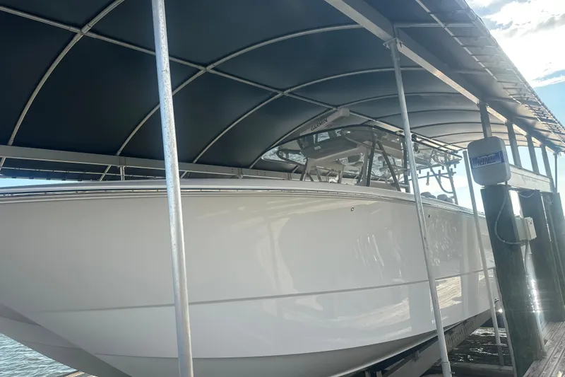 Slide: The Image of 2023 Invincible 46 Catamaran on trailer under cloudy sky. - 3