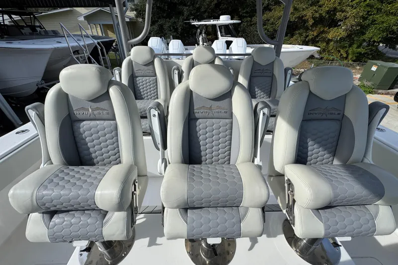 Slide: The Image of 2023 Invincible 46 Catamaran seats with gray and white upholstery, showcasing luxury design. - 30