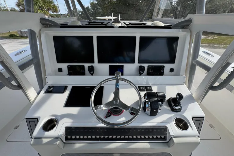 Slide: The Image of 2023 Invincible 46 Catamaran helm with advanced navigation displays and controls. - 33