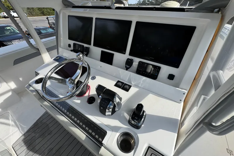 Slide: The Image of Helm of 2023 Invincible 46 Catamaran with advanced navigation displays and controls. - 35