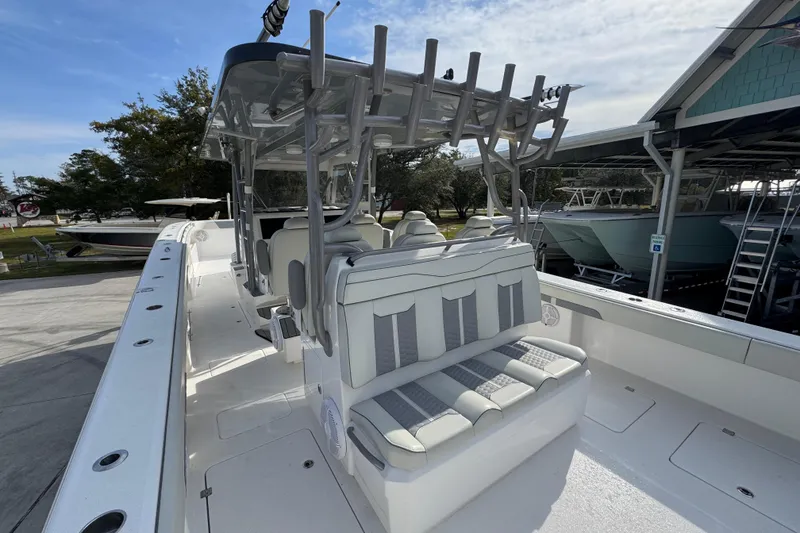 Slide: The Image of 2023 Invincible 46 Catamaran with sleek seating and modern design in a marina setting. - 38