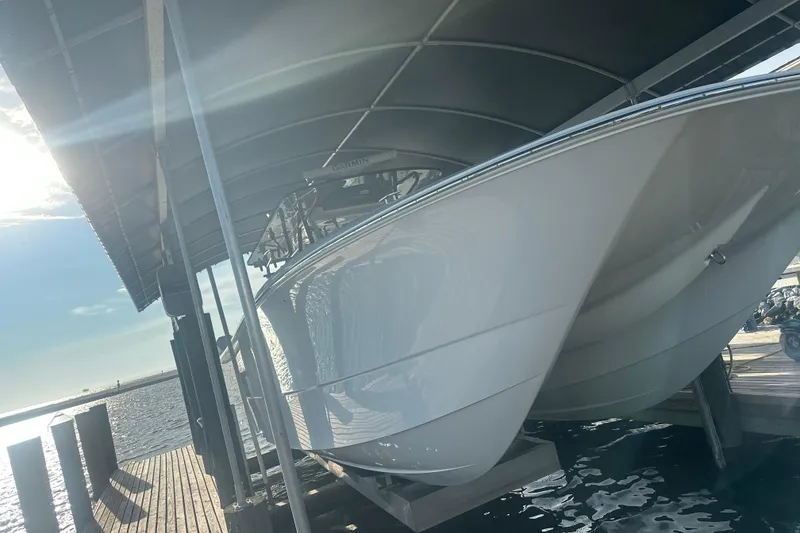 Slide: The Image of 2023 Invincible 46 Catamaran on trailer under a partly cloudy sky. - 4