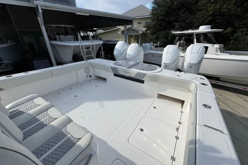 Slide: The Image of 2023 Invincible 46 Catamaran with spacious deck and powerful outboard engines. - 42