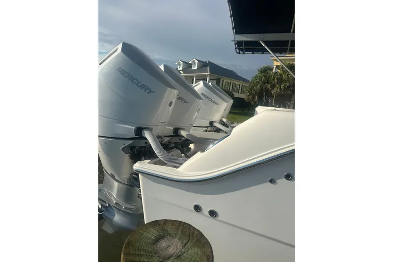 Slide: The Image of 2023 Invincible 46 Catamaran in a boatyard under a clear blue sky. - 7