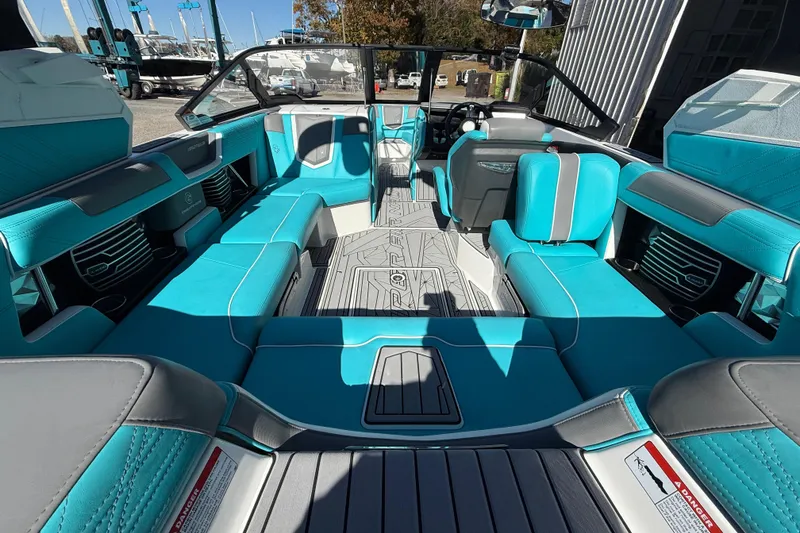 Slide: The Image of 2019 Nautique Super Air Nautique G21 interior with turquoise and gray seating. - 10