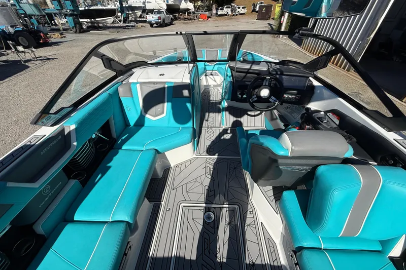 Slide: The Image of 2019 Nautique Super Air Nautique G21 interior with turquoise seating and modern dashboard. - 11