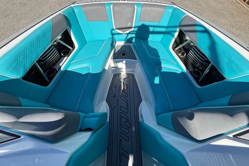 Slide: The Image of 2019 Nautique Super Air Nautique G21 boat interior with turquoise and gray seating. - 16