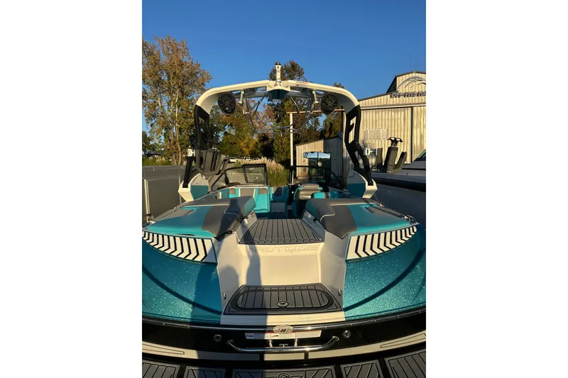 Slide: The Image of 2019 Nautique Super Air Nautique G21 boat on trailer, metallic teal and white design. - 3