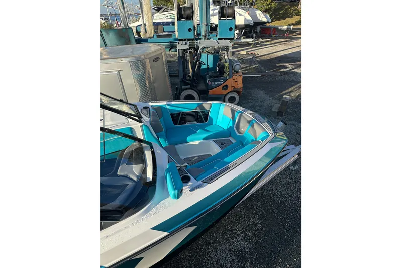 Slide: The Image of 2019 Nautique Super Air Nautique G21 boat on trailer, teal and white design. - 7