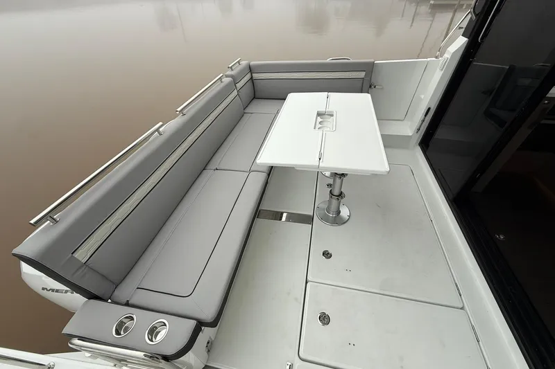 Slide: The Image of 2026 Jeanneau NC 1295 Coupe boat deck with sleek seating and modern table design. - 34
