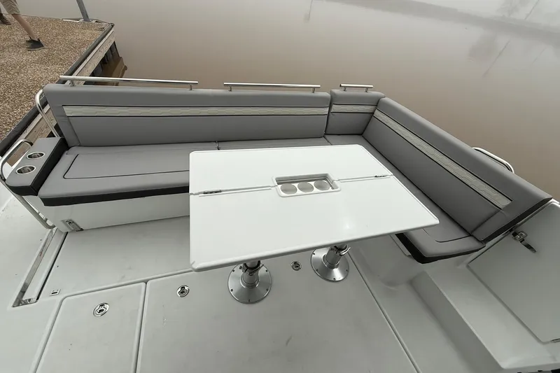 Slide: The Image of 2026 Jeanneau NC 1295 Coupe boat with sleek seating and modern table design. - 35