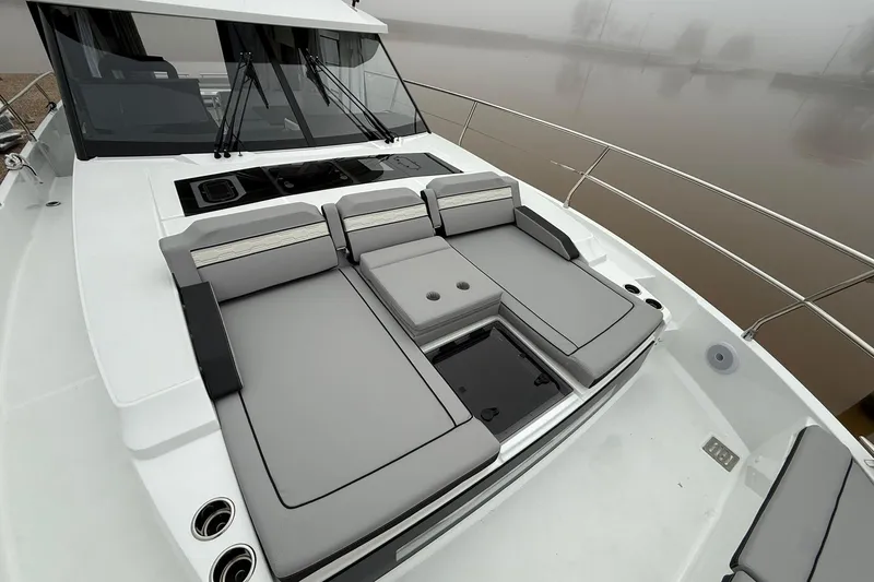 Slide: The Image of 2026 Jeanneau NC 1295 Coupe boat with sleek deck seating and modern design. - 37