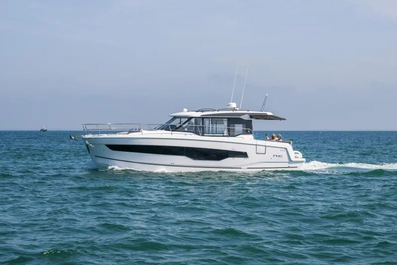 Slide: The Image of 2026 Jeanneau NC 1295 Coupe cruising on open water. - 6