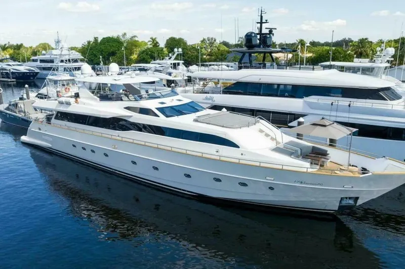 Slide: The Image of Luxury Tecnomar 35 Nadara yacht, 2006 model, docked in a marina with other vessels. - 0