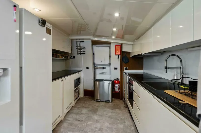 Slide: The Image of Modern kitchen interior on 2006 Tecnomar 35 Nadara yacht, featuring sleek appliances and cabinetry. - 11