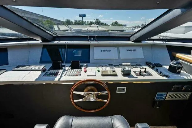 Slide: The Image of Control panel of 2006 Tecnomar 35 Nadara yacht with steering wheel and navigation equipment. - 12