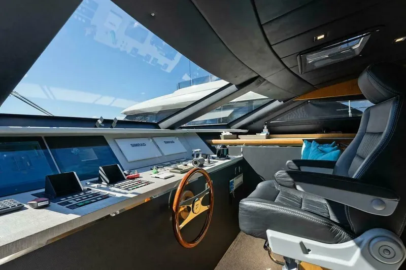 Slide: The Image of Luxurious helm of 2006 Tecnomar 35 Nadara yacht with modern controls and leather seating. - 13