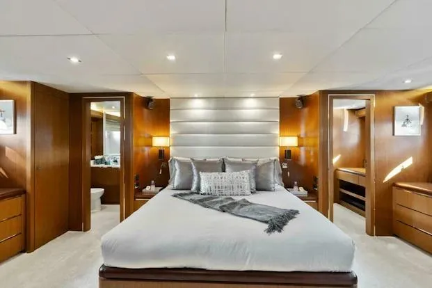 Slide: The Image of Luxurious bedroom interior on 2006 Tecnomar 35 Nadara yacht, featuring elegant wood finishes. - 17