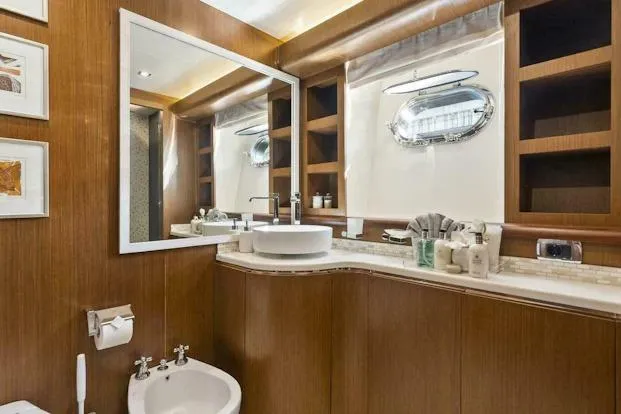 Slide: The Image of Luxurious bathroom on 2006 Tecnomar 35 Nadara yacht with modern fixtures and wood accents. - 18