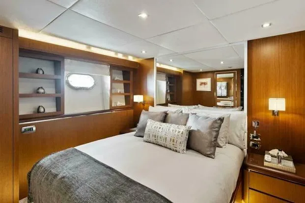 Slide: The Image of Luxurious bedroom interior on 2006 Tecnomar 35 Nadara yacht, featuring elegant wood paneling. - 19