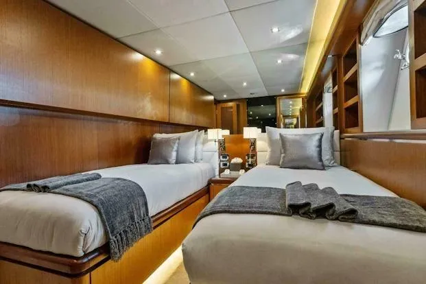 Slide: The Image of Luxurious twin cabin interior of 2006 Tecnomar 35 Nadara yacht, featuring elegant wood paneling. - 21