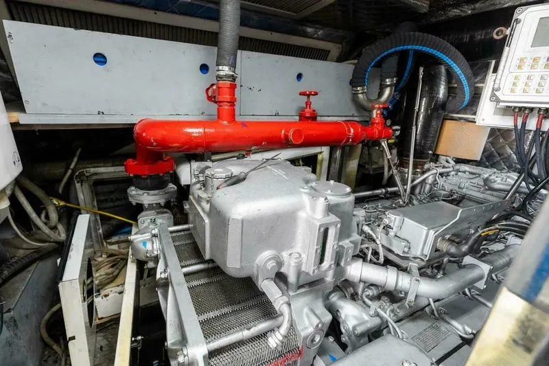 Slide: The Image of Engine room of 2006 Tecnomar 35 Nadara yacht, featuring complex machinery and red piping. - 24