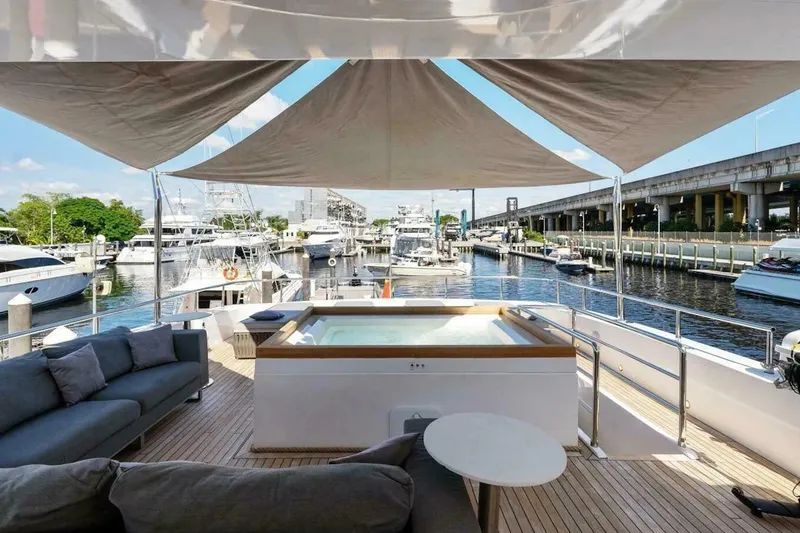 Slide: The Image of Luxury Tecnomar 35 Nadara yacht deck with jacuzzi and seating, docked at marina, 2006 model. - 6