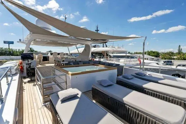 Slide: The Image of Luxurious 2006 Tecnomar 35 Nadara yacht deck with sun loungers and jacuzzi under a clear sky. - 7