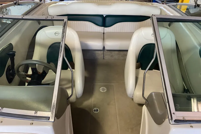 Slide: The Image of Interior of a 2004 Crownline 192 BR boat with white and green seating. - 12