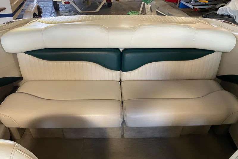 Slide: The Image of 2004 Crownline 192 BR boat interior seating, white and green upholstery. - 13